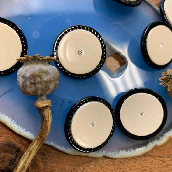 Пуговицы пластиковые цвета топлёного молока в черной оправе и камешком