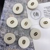 Пуговицы пластик матовый молочный с буквами CD, 23 мм